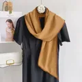 Detail of houndstooth silk scarf in brown and yellow draped on a black dress neck - Khaki Small Houndstooth