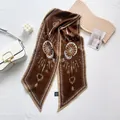Detail of vintage key print silk scarf with chain pattern on white leather bag - Brown Vintage Key Pattern