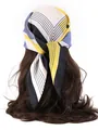 Detailed styling of geometric printed silk scarf tied on long wavy hair in close-up shot - Geometric - Blue and Yellow