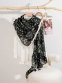 Dettaglio di una sciarpa lunga e sottile con motivo paisley bianco e oro su nero - Paisley Vintage - Nero