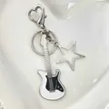 Y2K electric guitar keychain with a hollow star charm and a heart-shaped carabiner - White