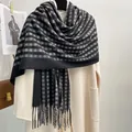 Classic black and grey plaid cashmere-like scarf with fringe on a beige coat - Striped Plaid - Black