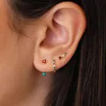 Three-piece gold plated brass earring set with red and green gemstones on ear model - Colorful Rhinestone Style (Style 35)