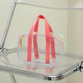 Detail of pink fabric handles and purple PVC edging on the clear jelly tote bag - Small / Transparent with Pink (Small)