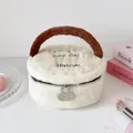 Detail van de pluche witte make-uptas met bruin handvat en dubbele metalen ritsen - Broken Wit