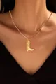 Detailed view of a gold-plated brass boot pendant necklace on a female model - Cowboy Boot Style (x129)