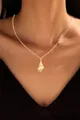 Detail of gold-plated brass necklace featuring a textured conch pendant on a model - Shell Conch Style (x131)
