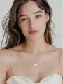 On-model view of golden brass rabbit pendant necklace with red bead earrings set - Rabbit Necklace And Earrings Set (x438)