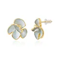 Macro view of gold-plated floral earrings with blue enamel petals and textured details - Enamel Flower Stud Style / Gold