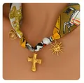 Vintage silk ribbon choker with gold cross heart and sun charms on a model's neck - Black and Yellow Vintage Print Choker (x549) / 14k / Gold