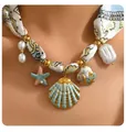 Detailed shot of ocean-style ribbon necklace with gradient shell and starfish pendants - Blue Ocean Shell Satin Necklace (x545)