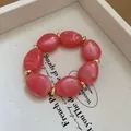 Detailed shot of pink marble acrylic beads and gold ring spacers on a beaded bracelet - Pink Irregular Beaded Bracelet