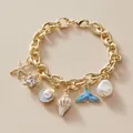 Golden chunky link bracelet with ocean charms like starfish, fish tail and white pearls - Gold Ocean Charm Bracelet