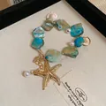 Marine acrylic beaded bracelet with starfish pendant and sea shell details in blue - Blue Ocean Shell Bracelet