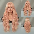 Long wavy synthetic wig in light peach pink with bangs and natural fiber texture - Dreamy Pink Orange