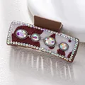 Macro shot of hair claw featuring cow print fabric, colorful rhinestones and faux gems - Cow Print Four Faceted Rainbow Stone Style (F731-18)