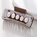 Detail of bohemian hair claw clip featuring faux fur, white marble stones and rhinestones - Cow Print Five White Marble Style (F731-16)