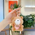 Close-up of a brown plush bear keychain with a pink polka dot scarf and YYDS leather tag - Hanging Chain / Brown