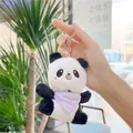 Detail of plush panda keychain with purple polka dot scarf held in hand as bag charm - Silver Clasp / Purple Bib