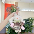 Detail of white lop-eared rabbit plush toy with lace dress and tulip accents - Removable Dress / Brown Plaid Dress