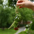 Green plush dinosaur keychain featuring a soft Tyrannosaurus Rex toy with golden metal clip - 11cm / Gold Keychain / Dark Green