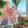 Detailed view of a plush alpaca keychain with soft white head and light brown spotted body - Gold Metal Buckle / Brown