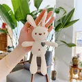 Close-up of knit plush bunny pendant with gray heart and metallic ball chain detail - Cream White - Green Heart - Silver Bead Chain
