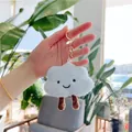 Close-up of a cute plush blue cloud keychain with embroidered smile and golden ring - Gold Clasp / Blue