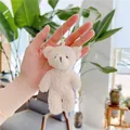 Detail of a creamy beige teddy bear plush keychain featuring curly sherpa faux fur texture - Plain Chain / Off White / Approx. 12cm