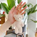 Close-up of cream teddy bear plush keychain with curly fleece and gold lobster clasp - Gold Clasp / Off White / Approx. 12cm