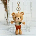 Brown teddy bear plush keychain wearing a beige plaid sweater and orange corduroy shorts - Gold Lobster Clasp / White Jacket
