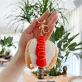 Close-up of cute hot dog plush keychain with mustard detail and gold metal clip - Hotdog (Gold Buckle) / 8cm - 10cm