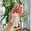 Handheld view of a cream plush teddy bear keychain with silver beaded chain detail - 10.5cm / Basic Style / Off White