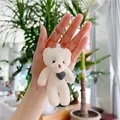 Detailed macro of white plush teddy bear keychain with grey corduroy heart accent - 10.5cm / Green Heart Decor / Off White