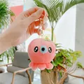 Pink plush octopus keychain with green flower and gold clasp hanging in hand - Gold Clasp / Rose Red