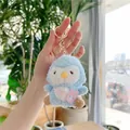 Detail of a soft blue plush penguin keychain with a tiny pink rabbit bag and golden clasp - Blue Penguin Style-Gold Clasp / Blue