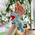 Detailed close-up of a blue plush dinosaur keychain with yellow stripes and metal ring - Gold Clasp / Blue / 16cm