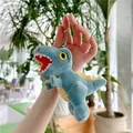 Close-up of a plush dinosaur keychain in blue with yellow fins and a metal clip - Plain Chain / Blue / 16cm