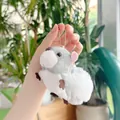 Close-up of a cute plush squirrel keychain being held by hand in a bright indoor garden - Gray (Bead Chain) / 13cm