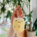 Close-up of yellow plush bubble tea keychain with pineapple embroidery held by hand - Pineapple Milk Tea - Gold Clasp