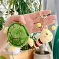 Funny turtle and bee plush keychains with golden metal hooks held in hand outdoors - Separable Body (Gold Buckle) / Yellow Green