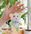 Close-up of cute panda plush keychain with blue bowtie and rose gold metal clasp detail - Gold Clasp Style / Yellow / 13cm