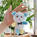 Close-up of cute plush panda keychain with blue ears and black-white checkered bowtie - Bead Chain Style / Blue / 13cm