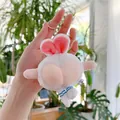 Funny white plush bunny keychain featuring a pink peach butt design and blue striped legs - White Chain
