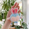 Detailed view of creative funny peach butt bunny plush keychain with soft blue fabric - Blue Gold Hook