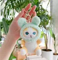 Close-up of plush cat keychain with mint green rabbit ear hat and golden metal clasp - Gold Clasp / Green