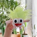 Detailed shot of pink plush toy with green messy hair and striped socks accessory - Gold Clasp / Light Green