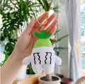 Cute white radish plush keychain with a sad expression and green leaf detail - White Radish / Gold Clasp