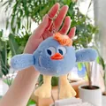 Close-up of cute blue plush monster keychain with orange flower and metal ring - Hanging Chain / Blue