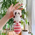Cute pink and white plush raccoon keychain with gold clasp held in hand outdoors - Gold Clasp / Pink